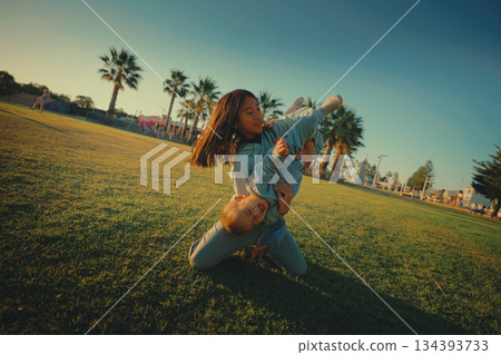 Playful Moments A Child Naturally Enjoying Fun Activities in the Park Playful Moments A Child Naturally Enjoying Fun Activities in the Park 134393733