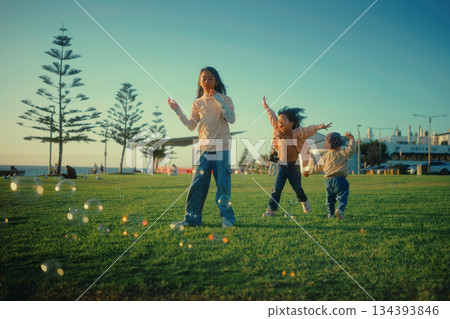 Joyful children are playing outside in the fresh air with colorful bubbles, 134393846