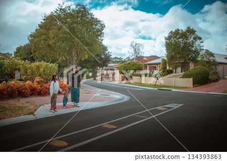 A Family is Spending Quality Time Together on a Sidewalk on a Cloudy Day 134393863