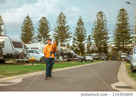 park staff in bright uniform surveys camping spots during sunny coastal afternoon 134393869