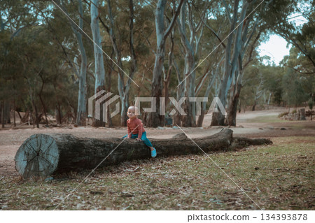 child exploring outdoors, child peacefully observing surroundings in tranquil outdoor 134393878