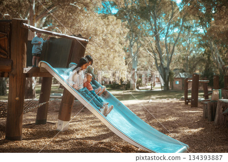 Joyful Moments at the Playground Enjoying Sliding Fun with Kids and Family Activities 134393887