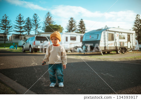 toddler explores outdoors, child beginning independent exploration at sunny caravan park toddler explores outdoors, child beginning independent exploration at sunny caravan park 134393917