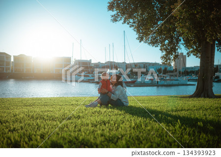 romantic couple by marina, couple sharing picnic and embracing during serene sunset romantic couple by marina, couple sharing picnic and embracing during serene sunset 134393923