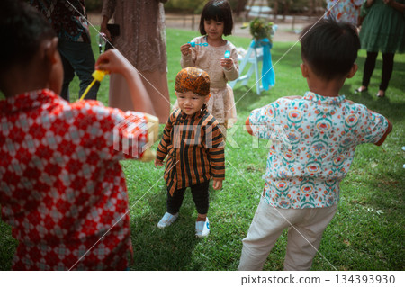 Children Enjoying Outdoor Playtime in Colorful Traditional Outfits Children Enjoying Outdoor Playtime in Colorful Traditional Outfits 134393930