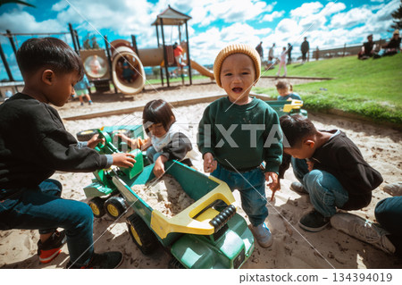 Children Playing Joyfully at the Playground with Toys and Friends 134394019