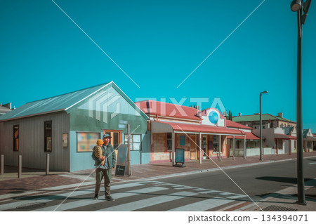 Charming Urban Streetscape with Colorful Shops and Clear Blue Sky Charming Urban Streetscape with Colorful Shops and Clear Blue Sky 134394071