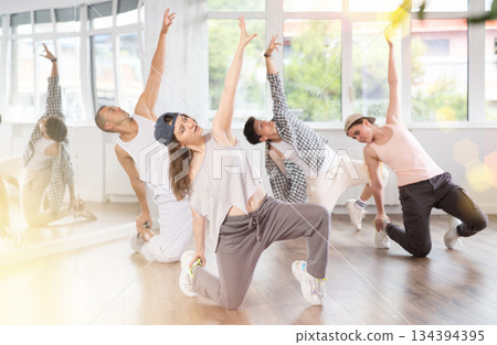 Break dance performed by a group of young dancers in dance studio 134394395