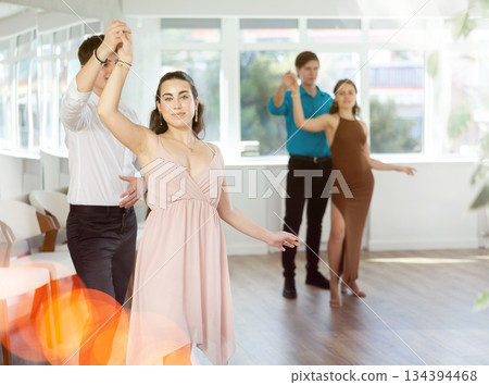 During rehearsal, guy and girl participants of dance workshop perform social pair dance During rehearsal, guy and girl participants of dance workshop perform social pair dance 134394468
