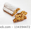 Stollen with filling of raisins, candied fruit 134394472