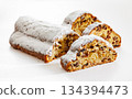 Stollen with filling of raisins, candied fruit 134394473