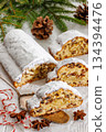 Stollen with filling of raisins, candied fruit 134394476