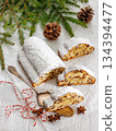 Stollen with filling of raisins, candied fruit 134394477