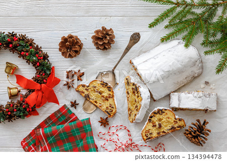 Stollen with filling of raisins, candied fruit 134394478