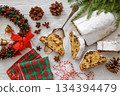 Stollen with filling of raisins, candied fruit 134394479