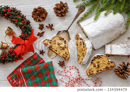 Stollen with filling of raisins, candied fruit 134394479