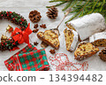 Stollen with filling of raisins, candied fruit 134394482