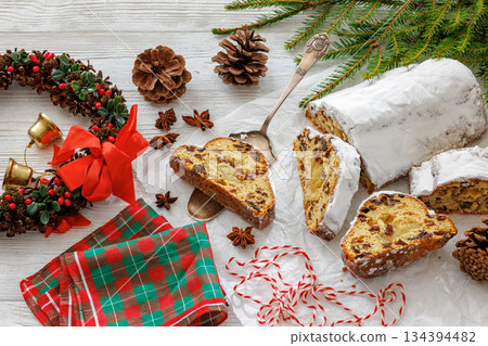 Stollen with filling of raisins, candied fruit 134394482