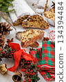Stollen with filling of raisins, candied fruit 134394484