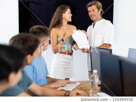 Among students of computer courses, male teacher awards diploma and to excellent girl pupil Among students of computer courses, male teacher awards diploma and to excellent girl pupil 134394550