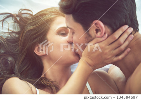 Bedroom love, kiss and face of couple relax for morning affection, calm or bonding quality time together in Canada. Smile, romantic vacation or marriage people in hotel bed for Valentines Day holiday 134394697