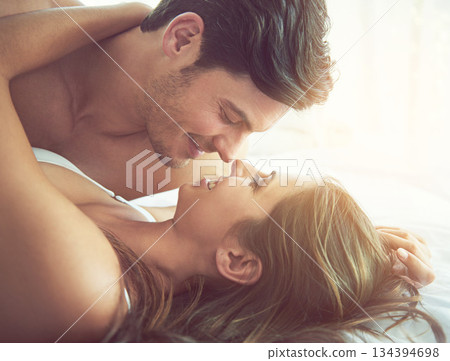 Love, face profile and bedroom couple relax for morning peace, calm and quality time together in Toronto Canada. Eye contact, romantic vacation and people bond on hotel bed for Valentines Day holiday 134394698