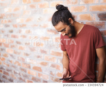 School, phone and university with man at brick wall space for social media, technology or internet. Eduction, learning and scholarship with male student on college campus for connection and contact School, phone and university with man at brick wall space for social media, technology or internet. Eduction, learning and scholarship with male student on college campus for connection and contact 134394724