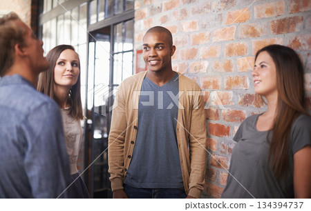 Talking, friends or students in a college hallway for discussion, happiness and a chat. Group of diversity men and women at campus or university for conversation about education career or school work 134394737