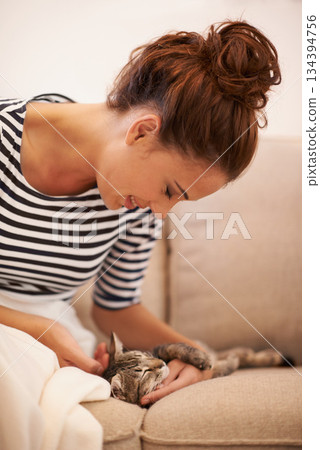 Happy, woman and cat on a sofa, relax and stress relief at home, smile and quality time. Female model, girl or person with kitten, stroke animal or pet on a sofa, relax and happiness in a living room Happy, woman and cat on a sofa, relax and stress relief at home, smile and quality time. Female model, girl or person with kitten, stroke animal or pet on a sofa, relax and happiness in a living room 134394756