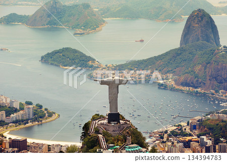 Brazil landscape, city and Christ the Redeemer on hill for tourism, sightseeing and travel destination. Traveling, Rio de Janeiro and aerial view of statue, sculpture and global landmark on mountain 134394783