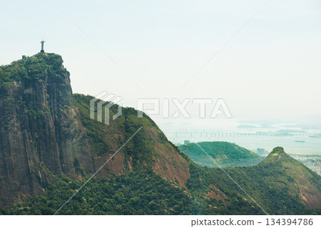 Mountain, nature and Christ the Redeemer in Brazil for tourism, sightseeing and travel destination. Landscape, Rio de Janeiro and drone view of statue, sculpture and landmark on hill background Mountain, nature and Christ the Redeemer in Brazil for tourism, sightseeing and travel destination. Landscape, Rio de Janeiro and drone view of statue, sculpture and landmark on hill background 134394786