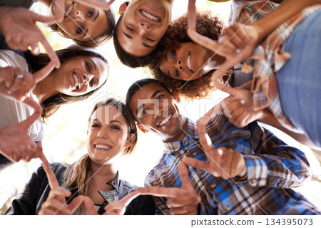 Portrait, finger star and friends in circle with diversity, unity and collaboration with low angle. Happy, smile and group of people in huddle together with hand gesture for solidarity and community. 134395073