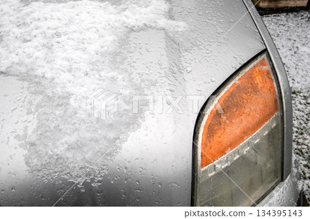 Snow Covered Car Hood With Ice Coated Front Turn Signal Light Snow Covered Car Hood With Ice Coated Front Turn Signal Light 134395143