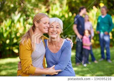 Family, mother and adult daughter hug in park, spending quality time in outdoor together with happiness and care. Happy women are content in relationship with love, bonding and carefree in nature 134395210