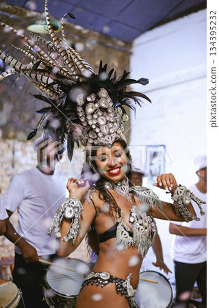 Celebration, party and exotic female dancer dancing with a band at mardi gras or cultural festival. Performance, costume and woman performing a dance with rhythm to live music at a carnival in Brazil 134395232