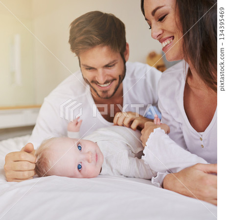 Happy family, baby and parents on bed for love, care and quality time together in house. Mom, dad and cute newborn kid relax in bedroom of home for childhood development, caring support and happiness Happy family, baby and parents on bed for love, care and quality time together in house. Mom, dad and cute newborn kid relax in bedroom of home for childhood development, caring support and happiness 134395469