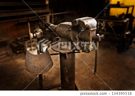 Vice, metal shop and warehouse with steel tools, manufacturing and blacksmith store. Workspace, factory tool and industry equipment with no people for welder craft and artisan worker workshop Vice, metal shop and warehouse with steel tools, manufacturing and blacksmith store. Workspace, factory tool and industry equipment with no people for welder craft and artisan worker workshop 134395516