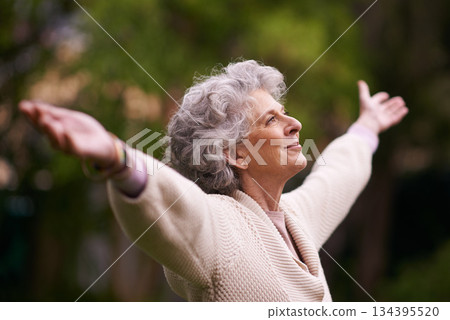 Senior, happy woman and celebrate life in nature, joy or retirement freedom outdoors. Face of elderly female smiling in happiness with arms out enjoying natural environment or vitality outside Senior, happy woman and celebrate life in nature, joy or retirement freedom outdoors. Face of elderly female smiling in happiness with arms out enjoying natural environment or vitality outside 134395520