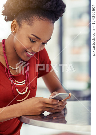 Phone, smile and black woman texting at table, online browsing or internet in restaurant. Cellphone, happy and African female person networking, social media and web scrolling on mobile technology. Phone, smile and black woman texting at table, online browsing or internet in restaurant. Cellphone, happy and African female person networking, social media and web scrolling on mobile technology. 134395604