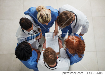 Above, doctor group and paperwork in a hospital and clinic with teamwork and collaboration. Medical team, nurse and healthcare workers with research paper and meeting in a circle with document Above, doctor group and paperwork in a hospital and clinic with teamwork and collaboration. Medical team, nurse and healthcare workers with research paper and meeting in a circle with document 134395608
