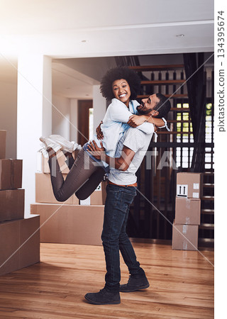 Moving in portrait, couple hug and love with real estate sale and cardboard boxes at new apartment. Happiness, excited and African woman and man together with a smile from mortgage and property deal Moving in portrait, couple hug and love with real estate sale and cardboard boxes at new apartment. Happiness, excited and African woman and man together with a smile from mortgage and property deal 134395674