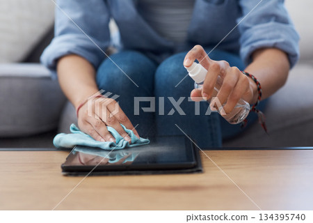 Woman, hands and cleaning tablet screen with spray and cloth, disinfectant and chemical detergent with closeup. Cleaner, antibacterial liquid or sanitizer, female person clean tech gadget and hygiene Woman, hands and cleaning tablet screen with spray and cloth, disinfectant and chemical detergent with closeup. Cleaner, antibacterial liquid or sanitizer, female person clean tech gadget and hygiene 134395740