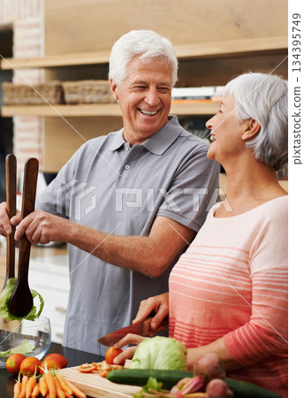 Cooking, health and laughing with old couple in kitchen for salad, love and nutrition. Happy, smile and retirement with senior man and woman cutting vegetables at home for food, dinner and recipe Cooking, health and laughing with old couple in kitchen for salad, love and nutrition. Happy, smile and retirement with senior man and woman cutting vegetables at home for food, dinner and recipe 134395749