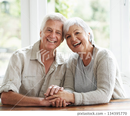 Portrait, laughing and senior couple holding hands for love, care and relax together at home. Face of happy old man, woman and helping hand for trust, support and loyalty to partner in retirement Portrait, laughing and senior couple holding hands for love, care and relax together at home. Face of happy old man, woman and helping hand for trust, support and loyalty to partner in retirement 134395770