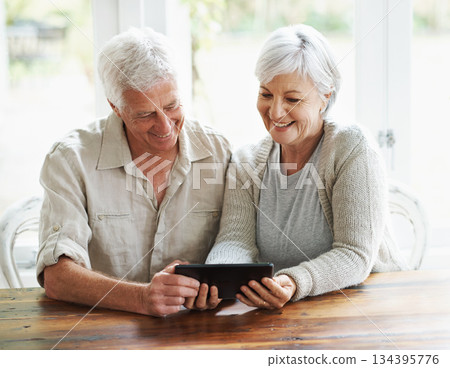 Tablet, happy senior couple and online in house with social media, reading news app and ebook. Retirement, old man and woman with digital technology for subscription, streaming and network connection 134395776