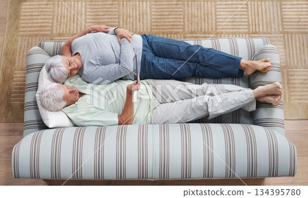 Top view, tablet and senior couple relax on sofa, social media and online app for ebook at home. Happy old man, woman and digital technology subscription, streaming and website on internet connection Top view, tablet and senior couple relax on sofa, social media and online app for ebook at home. Happy old man, woman and digital technology subscription, streaming and website on internet connection 134395780