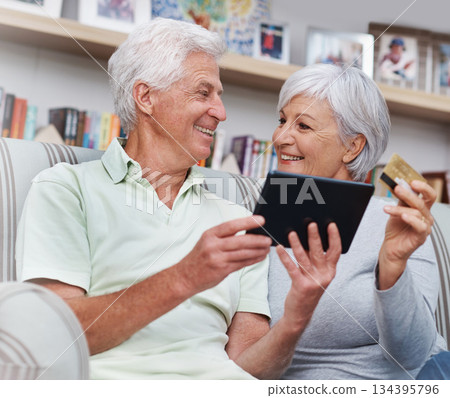 Senior couple, tablet and credit card for online shopping on living room sofa together at home. Happy elderly man and woman smiling on technology for ecommerce, banking app or payment on lounge couch Senior couple, tablet and credit card for online shopping on living room sofa together at home. Happy elderly man and woman smiling on technology for ecommerce, banking app or payment on lounge couch 134395796