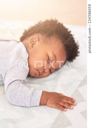 Comfort, bed and baby sleeping in home on blanket for rest, nap time and dreaming in nursery. Childcare, newborn and cute, tired and African child in bedroom sleep for comfortable, relaxing and calm Comfort, bed and baby sleeping in home on blanket for rest, nap time and dreaming in nursery. Childcare, newborn and cute, tired and African child in bedroom sleep for comfortable, relaxing and calm 134396059