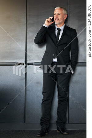 Phone call, businessman and happy for communication, contact and network in office. A senior entrepreneur person on a grey wall with a cellphone for conversation and thinking about corporate idea 134396076