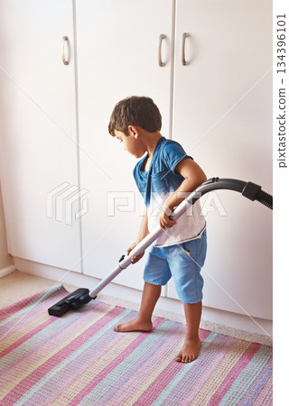 Vaccuming carpet, clean and a child in room for chores, learning and housework with a vacuum. Housework, house and a boy kid cleaning a mat for responsibility, routine and with machine in a bedroom Vaccuming carpet, clean and a child in room for chores, learning and housework with a vacuum. Housework, house and a boy kid cleaning a mat for responsibility, routine and with machine in a bedroom 134396101